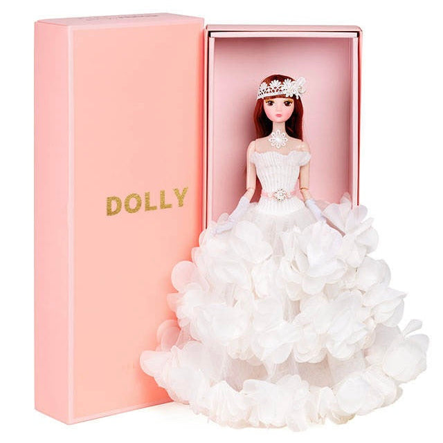 A doll named DOLLY® wearing a white flower tutu dress, presented in a pink ballet-themed gift box.