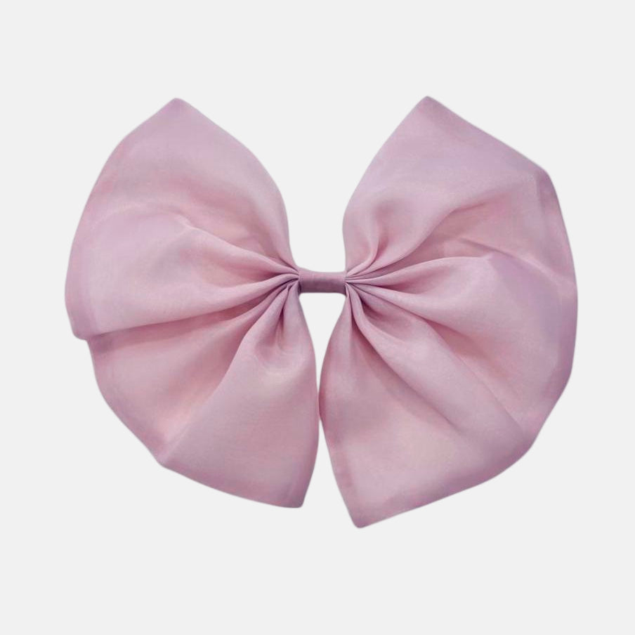 A dusty pink organza hair bow with a clip on the back, displayed against a white background.