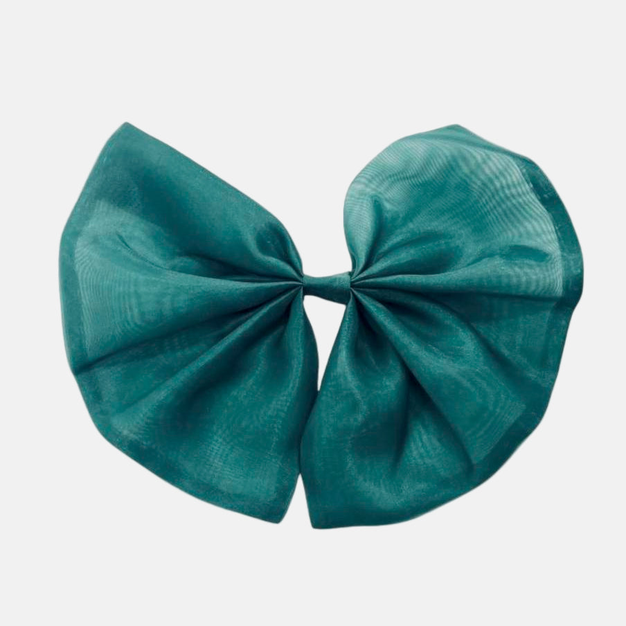A green organza hair bow with a clip attached, displayed on a white background.