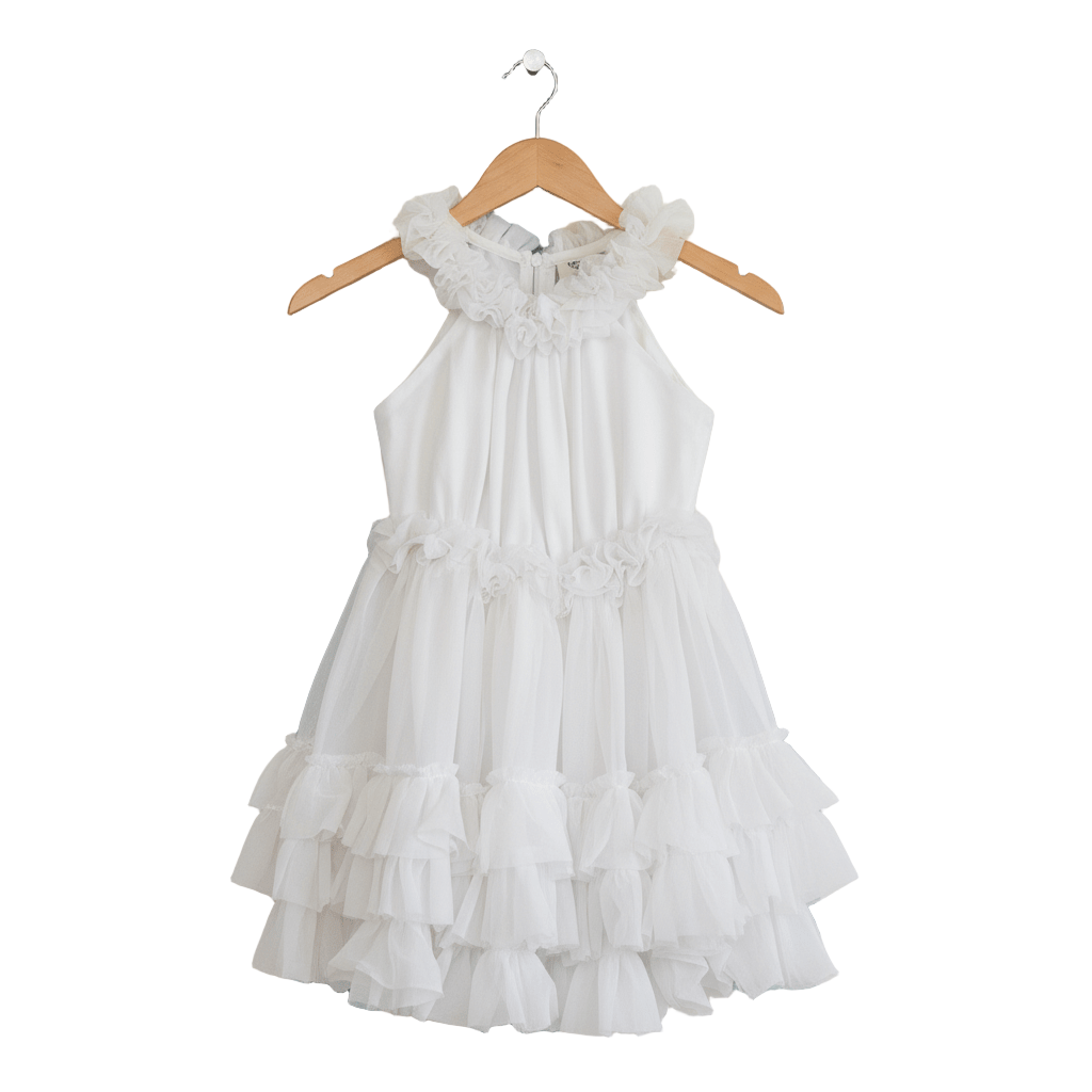 White ruffled dress on a wooden hanger against a white background