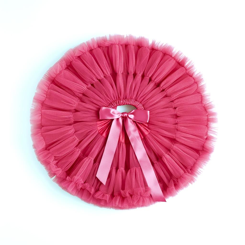 Pink tutu with a bow on a white background
