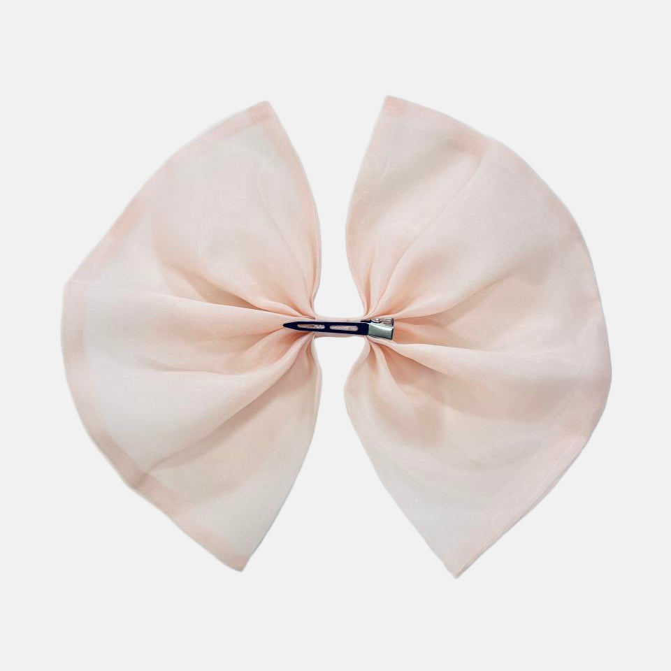 Large blush pink hair bow on a white background
