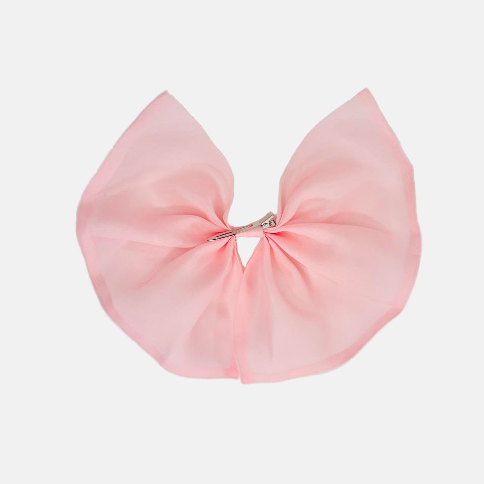 Large pink bow on a light gray background