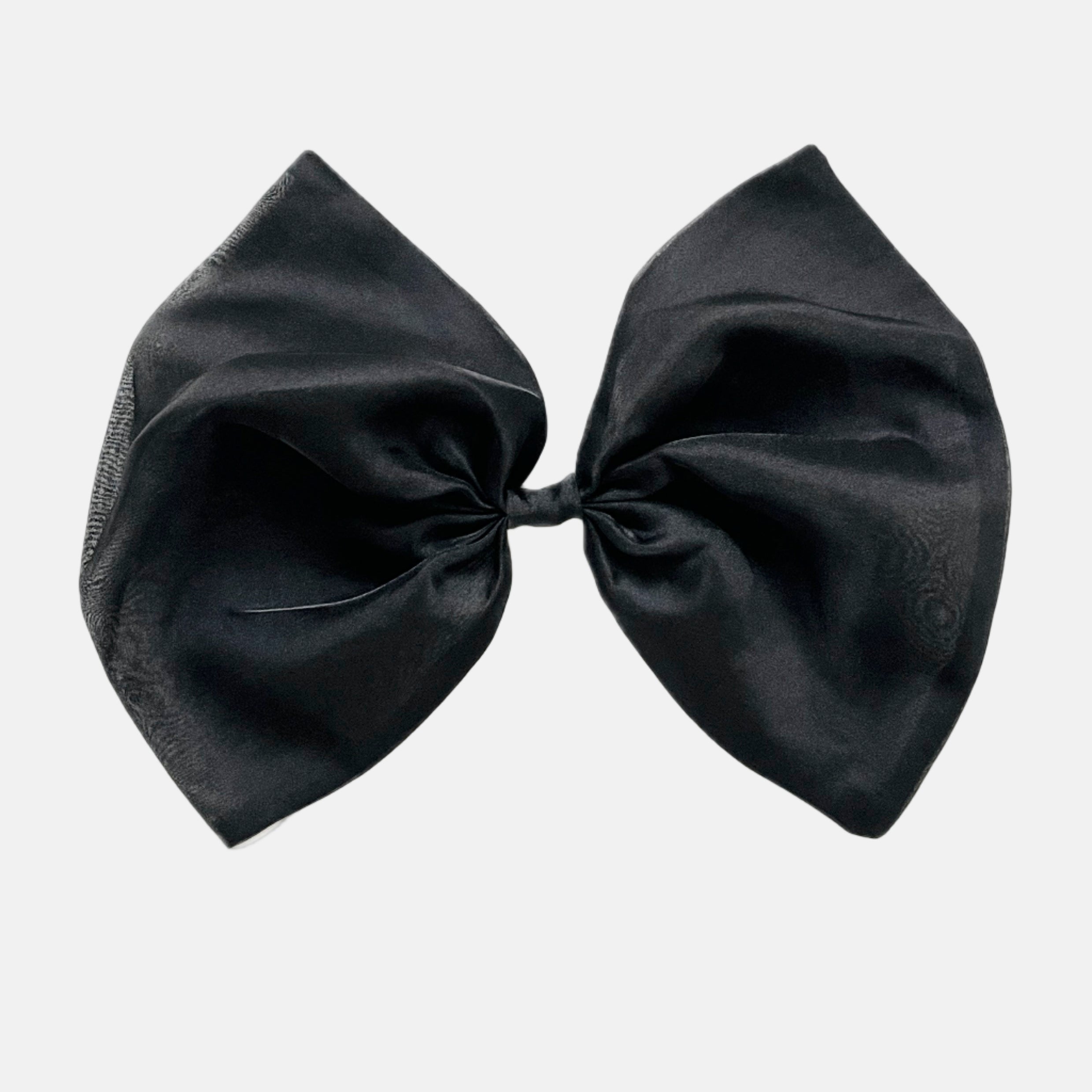 A black organza hair bow with a clip attached, displayed on a white background.