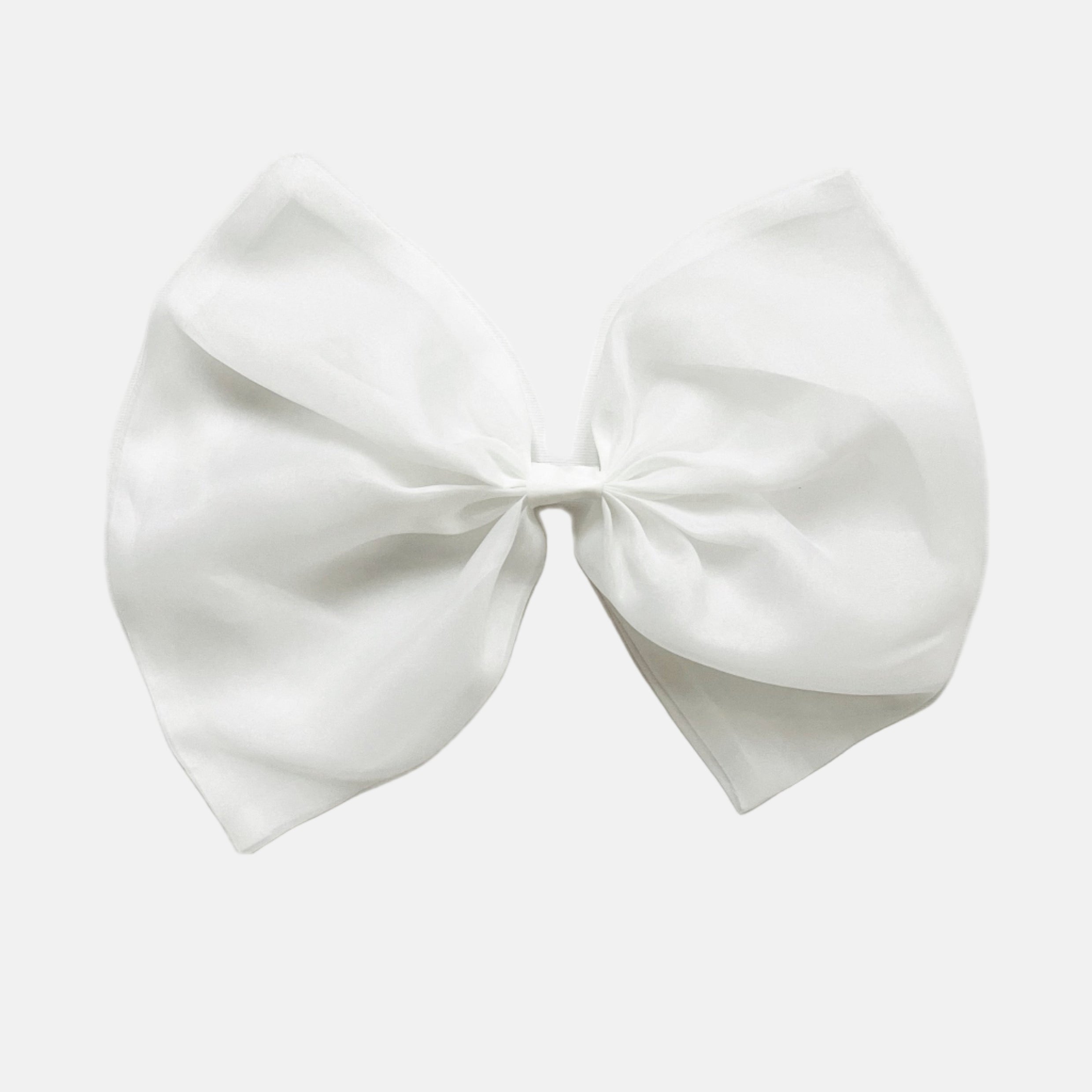 A white organza hair bow with a clip attached, displayed on a white background.