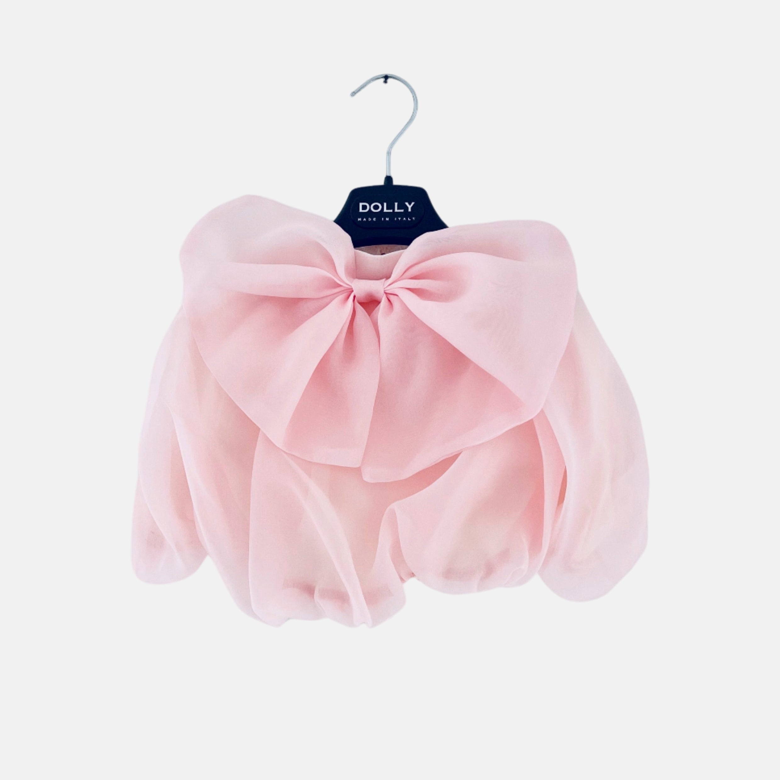 A pink organza skirt with a large bow, displayed on a hanger against a white background.