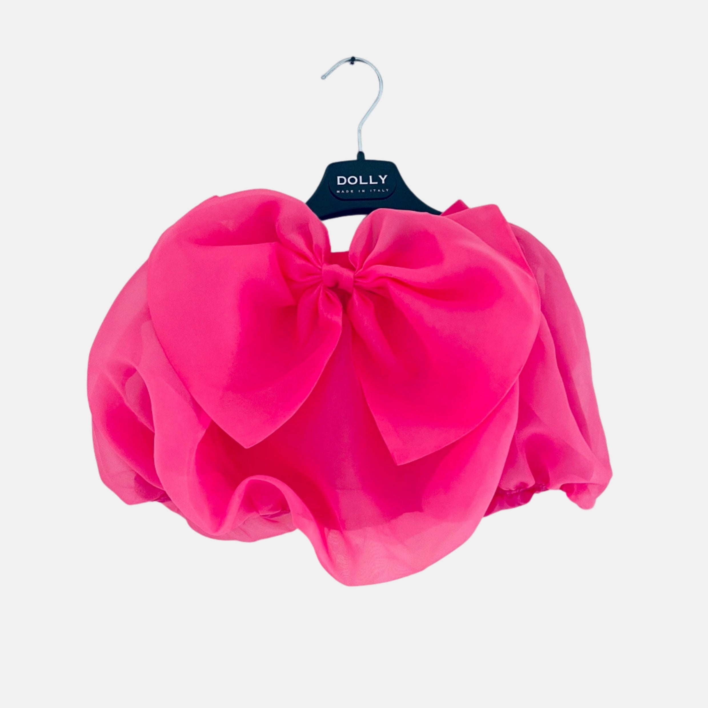A pink organza puff skirt with a large bow at the waist, displayed on a hanger against a white background.