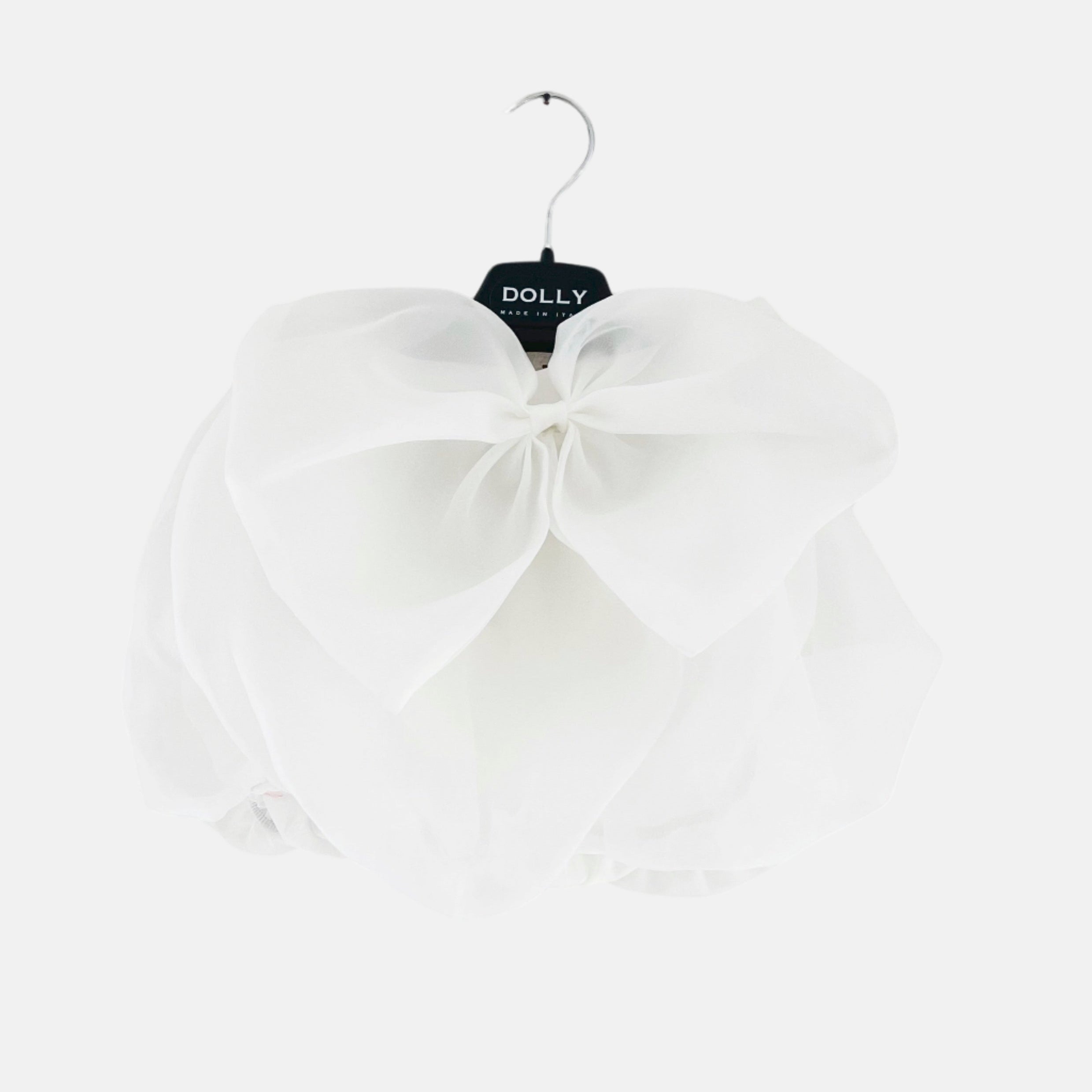 A white satin organza skirt with a big bow hanging on a hanger, part of the DOLLY WORLD collection.