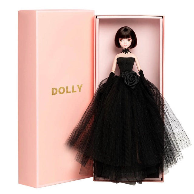 A DOLLY® Little Black Dress fashion doll with black tutu dress, displayed in a pink DOLLY® branded box.