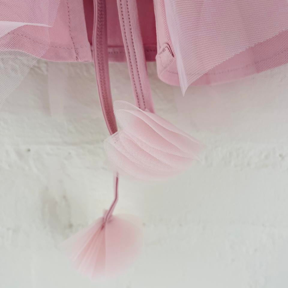 Close-up of a pink tulle fabric with a blurred background