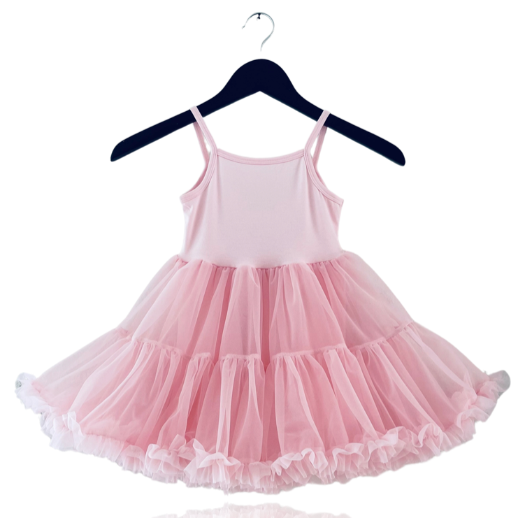 Pink dress on a hanger against a white background