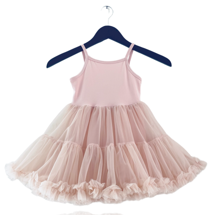 Pink dress with a tulle skirt on a hanger against a white background