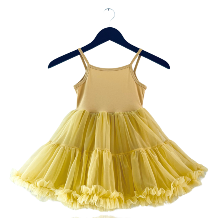 Yellow dress on a hanger against a white background