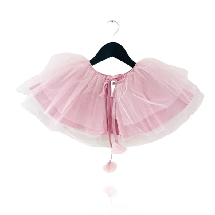 Pink tutu skirt on a hanger against a white background