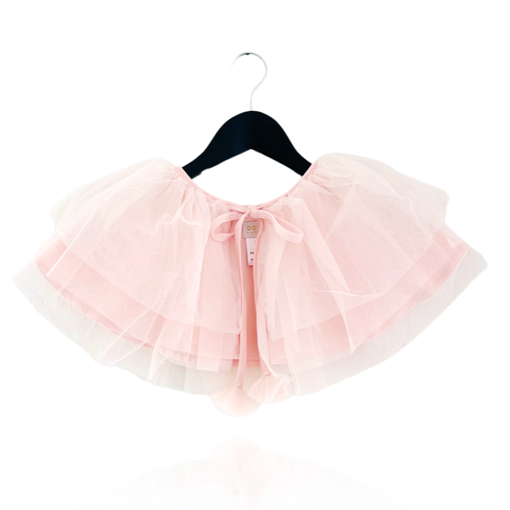 Pink tutu skirt on a hanger against a white background