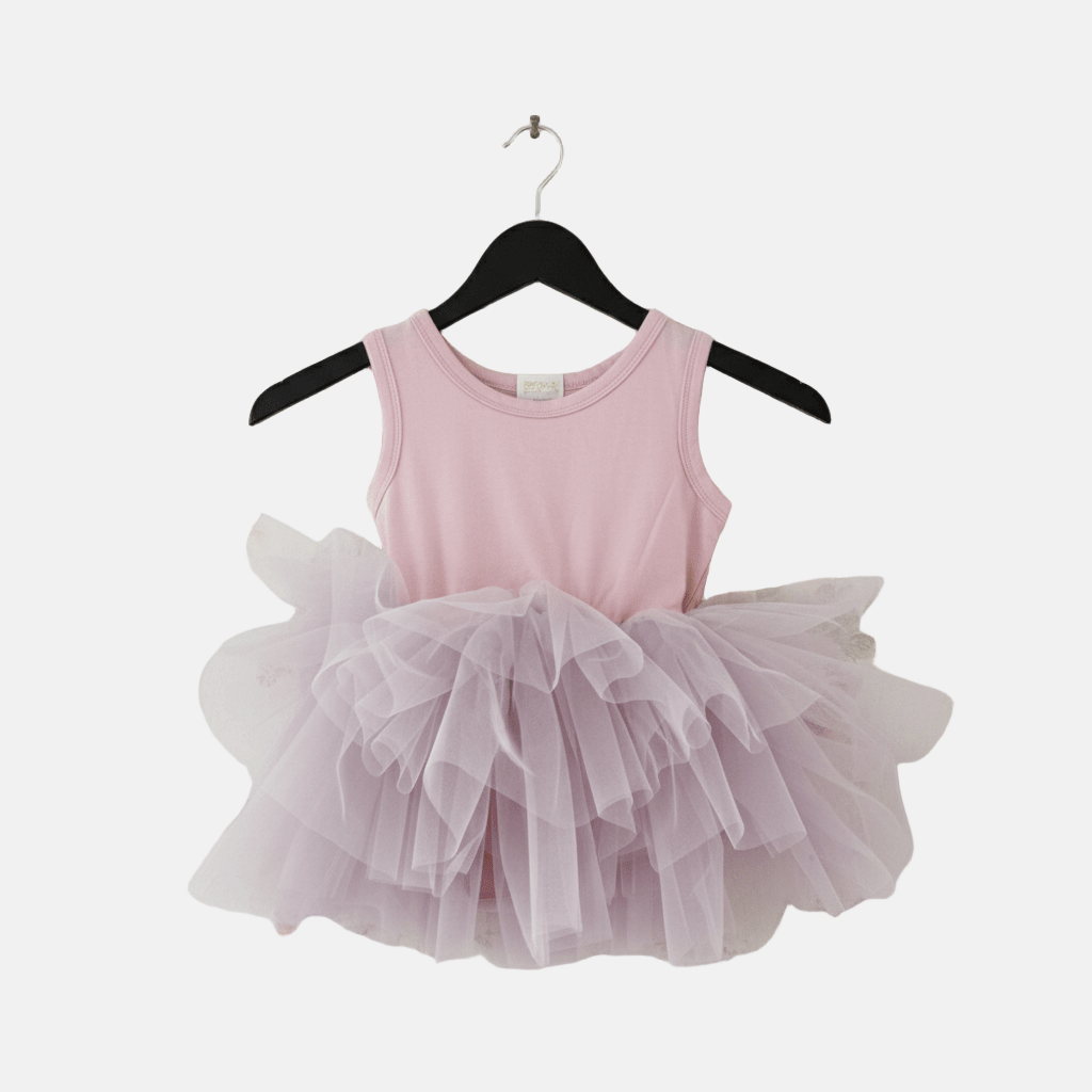 Pink dress with a tutu on a hanger against a white background