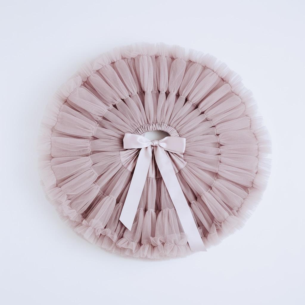 Pink tulle skirt with a bow on a white background