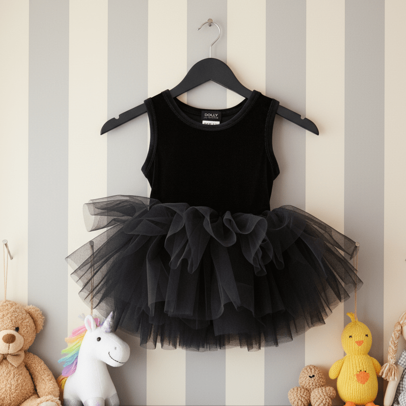 Black tutu dress on a hanger against a striped wall with toys below.