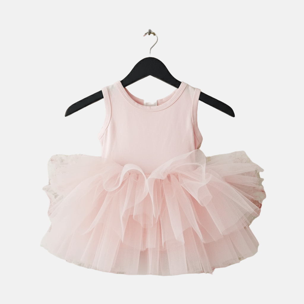 Pink tutu dress on a hanger against a white background
