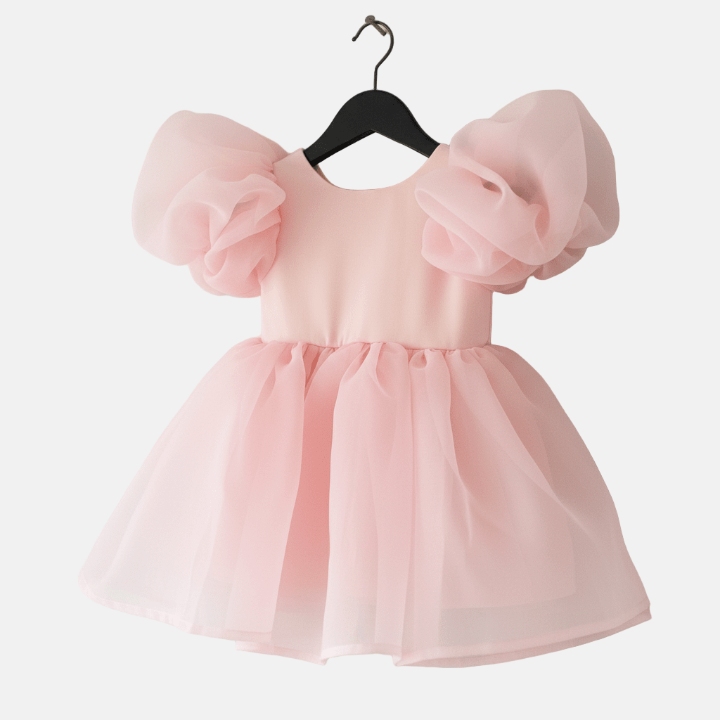 Pink dress with puff sleeves on a hanger against a white background