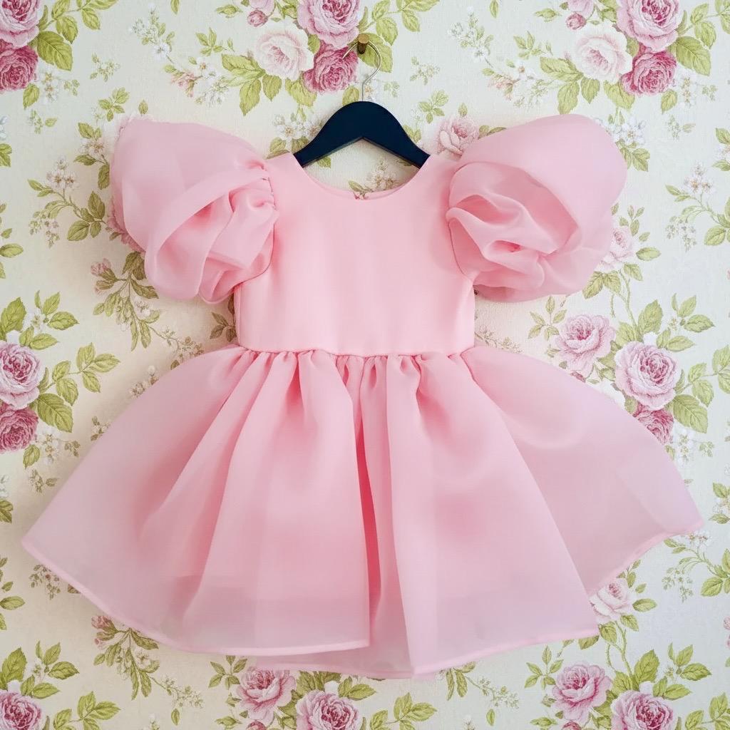 Pink dress with puff sleeves on a floral background