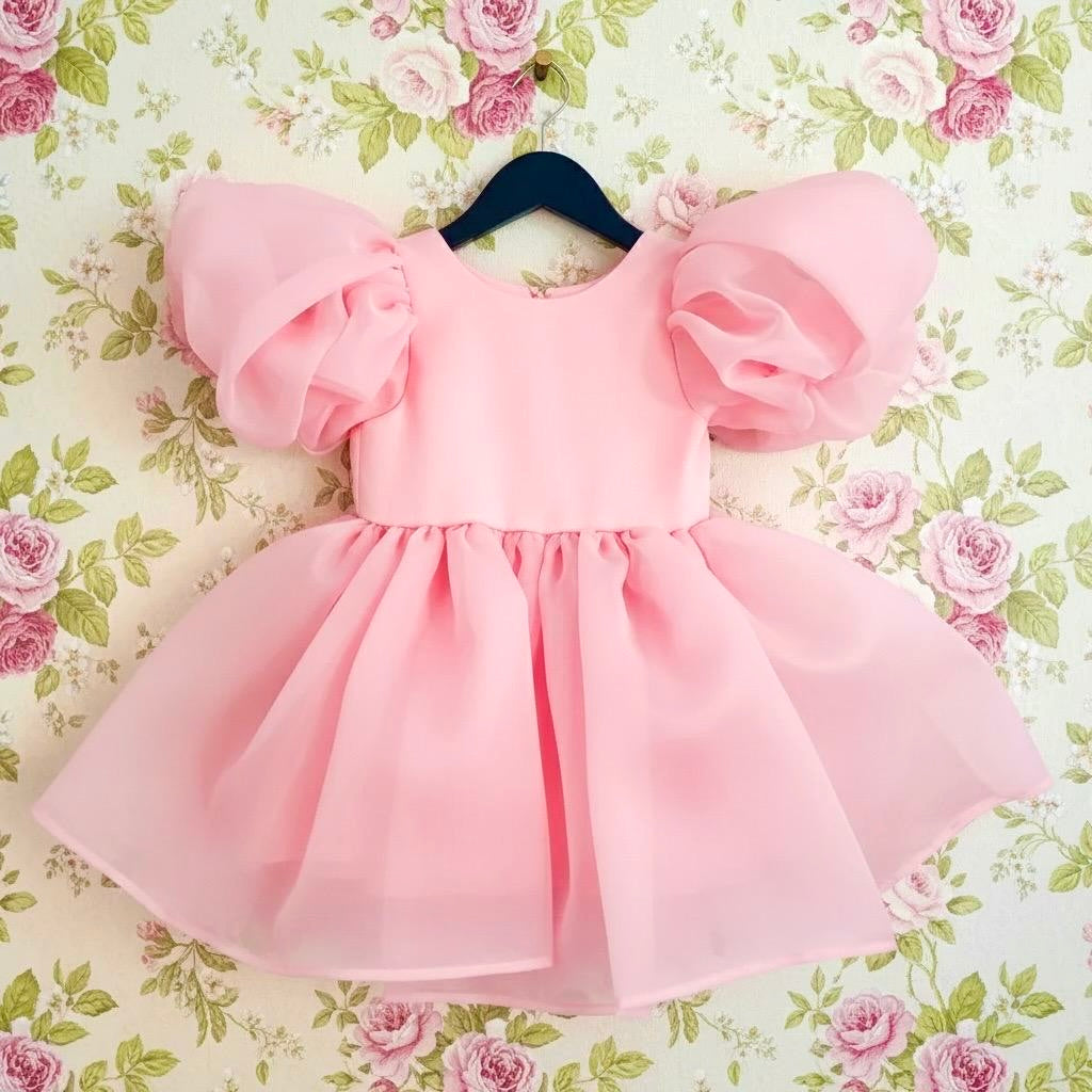 Pink dress with puffed sleeves on a floral background