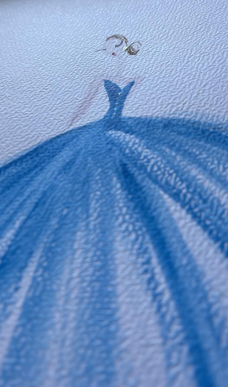 Close-up of a textured blue fabric with a small black and white illustration of a fish.