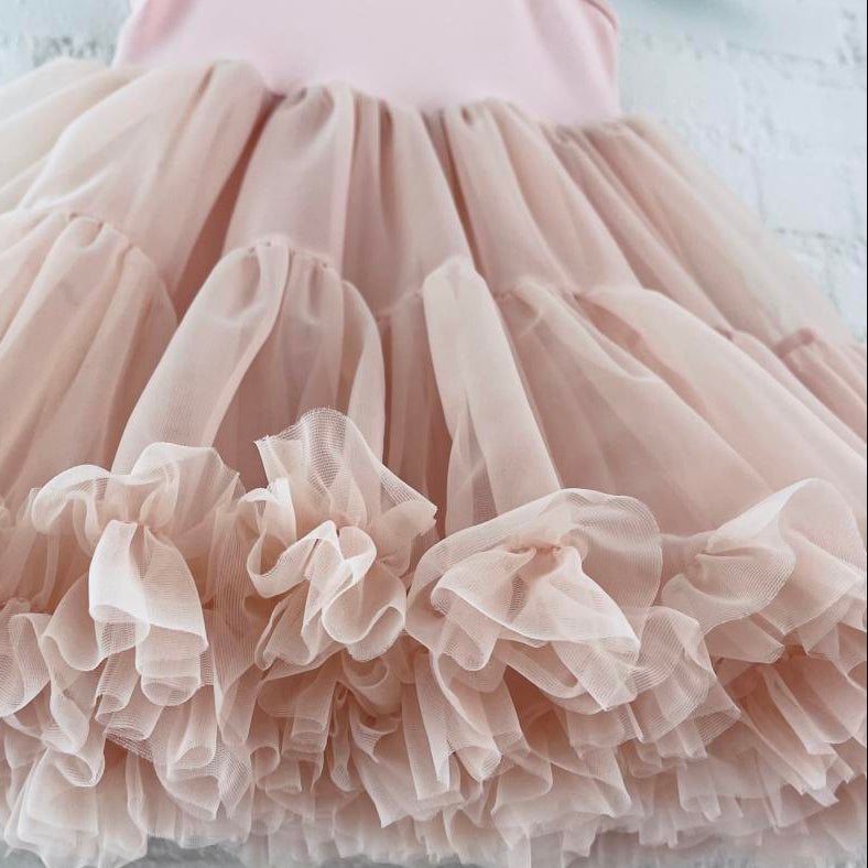 Close-up of a pink tulle skirt with a soft focus background